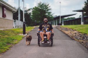 Jashar Banks, in wheelchair, returns to the program as a mentor for others after having experienced True Grit as a participant in 2024