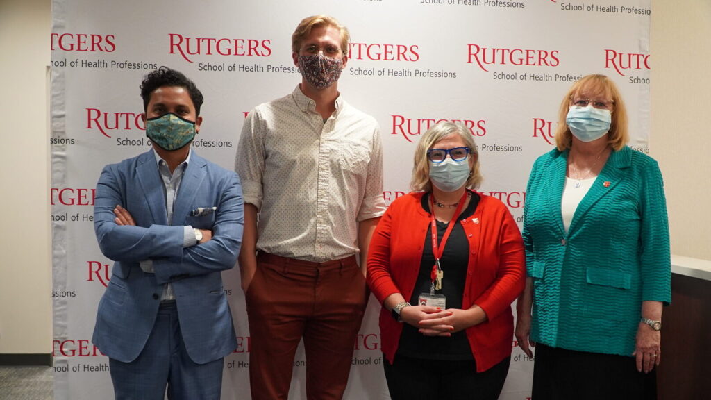 image of Hafiz Skider and Ryan Brown of the cancer nonprofit, Axiom Reach; Gwendolyn Mahon, dean of Rutgers School of Health Professions; and Linda Flynn, dean of Rutgers School of Nursing.