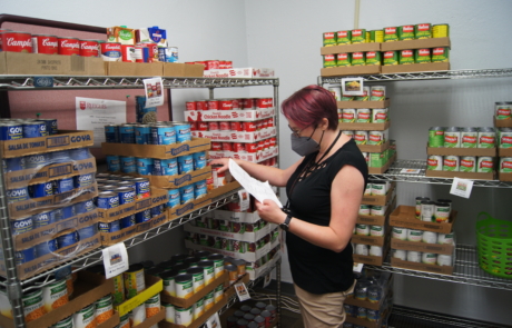 Volunteer stocking the shelves at the RBHS Food Pantry