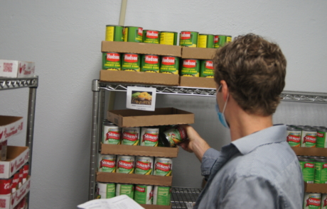Volunteer stock the shelves at the RBHS Food Pantry.