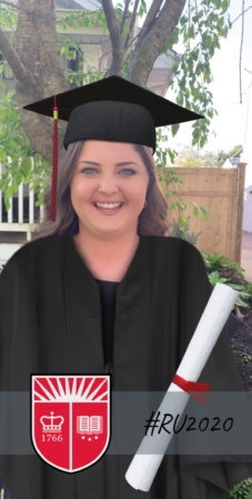 Jessica Easton in a cap and gown with the Rutgers Shield and digital diploma