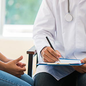 Young Asian woman patient having consultation with doctor, gynecologist or psychiatrist and examining health female illness, writing prescription clipboard record, Medical clinic in hospital cocept.